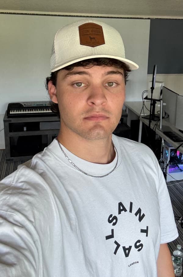 Loya’s saved reference photo, wearing a white cap and shirt